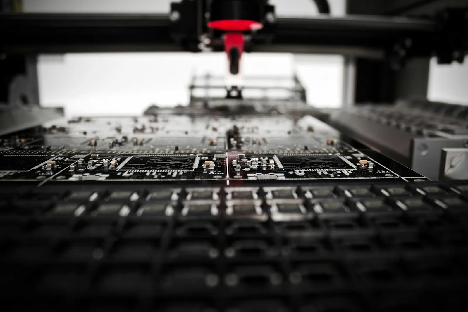 Automated pick-and-place machine populating printed circuit boards on a production line